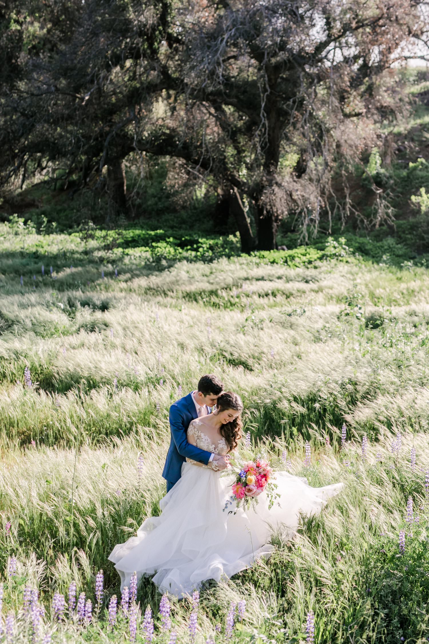 Bride and groom portraits in a field